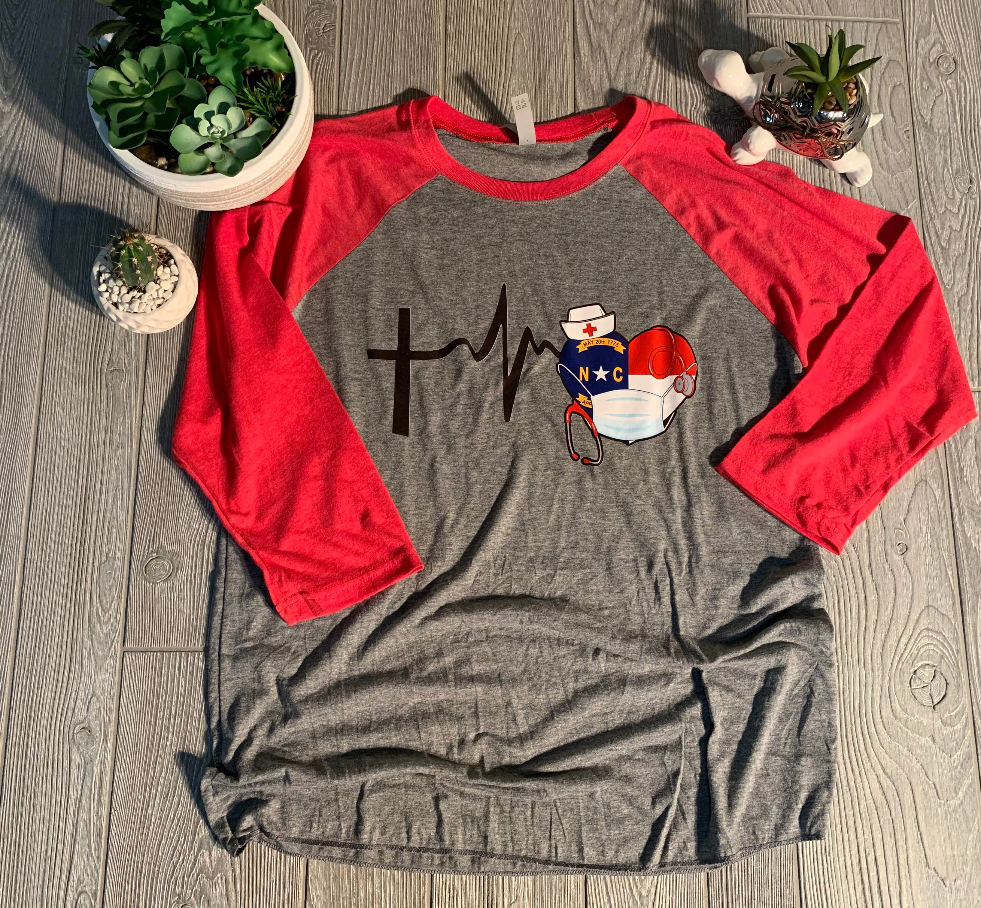 North Carolina - NC Flag Health Care Worker (Nurse) Heartbeat and Cross Shirt or Raglan